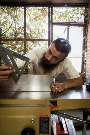 Man planning a wooden furniture design