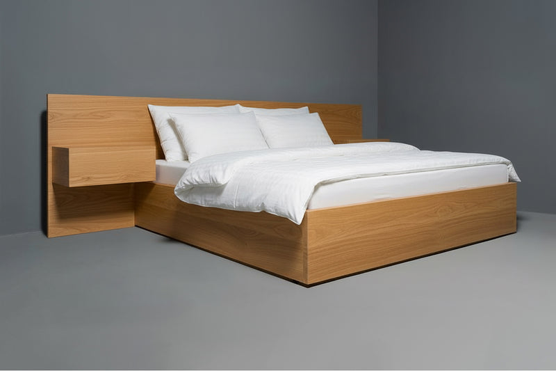 Handcrafted solid wood bed frame with in-drawer charging outlets, featuring a sleek sustainable design and integrated side storage.