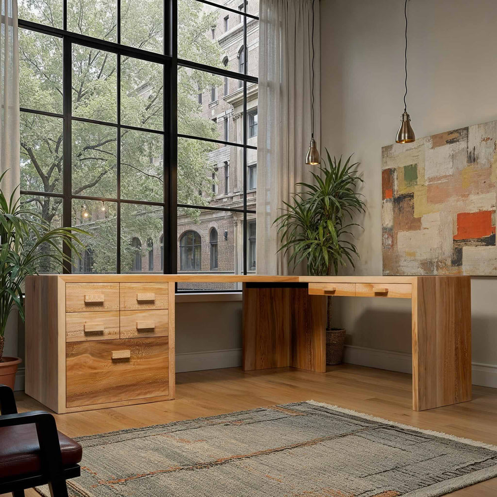 Handcrafted L-shaped solid wood desk with drawers in a bright room featuring large windows and modern decor