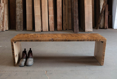 Custom natural wooden bench with a pair of shoes