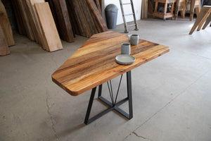 Custom-built wooden coffee table with irregularly-designed top and base patterns