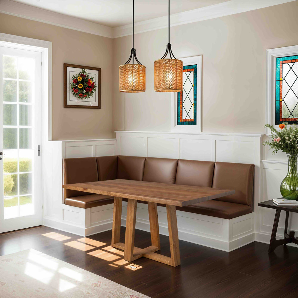 Custom handcrafted solid wood dining table paired with a cozy brown leather bench in a bright, stylish dining nook.