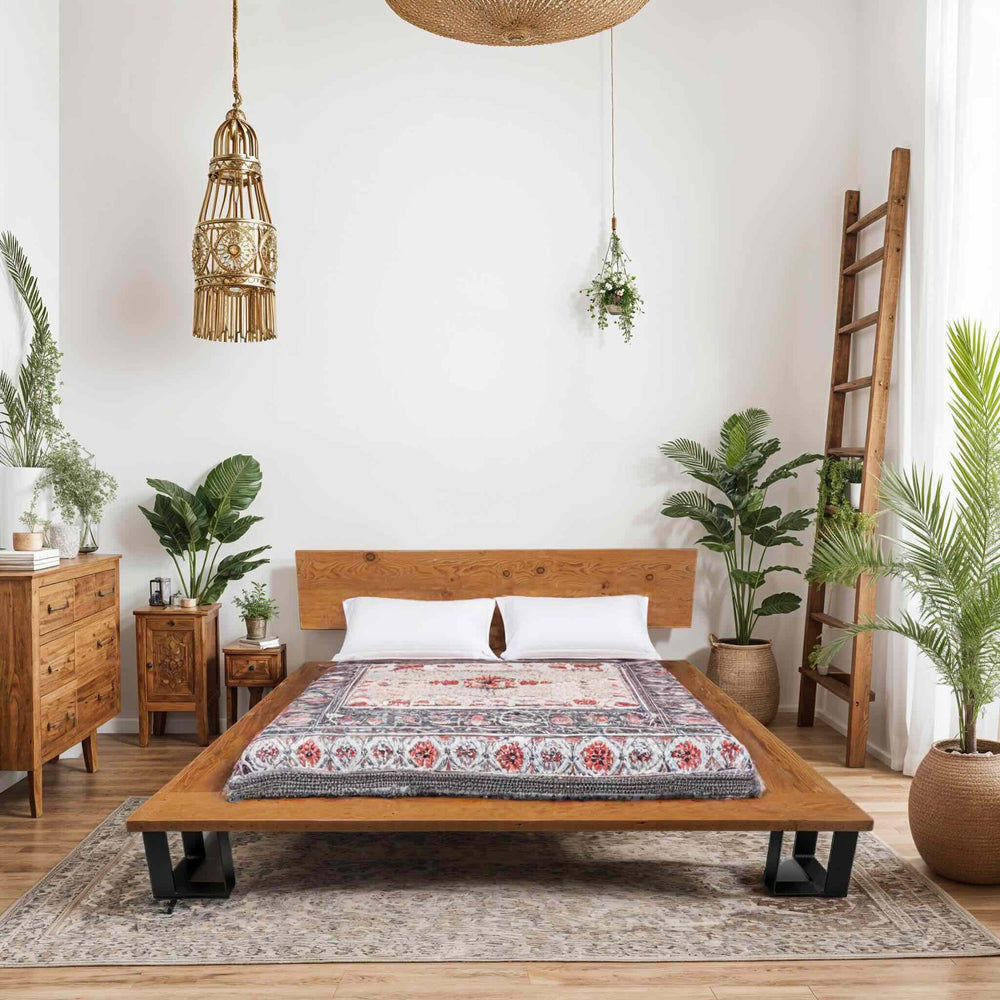 Handcrafted sustainable solid wood bed frame with clean lines in a bright, plant-filled minimalist bedroom setting