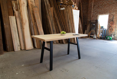 36"-tall bar table with thick table top made from natural wood and metal frame