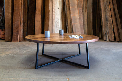Low, round wooden table with metal legs and frames