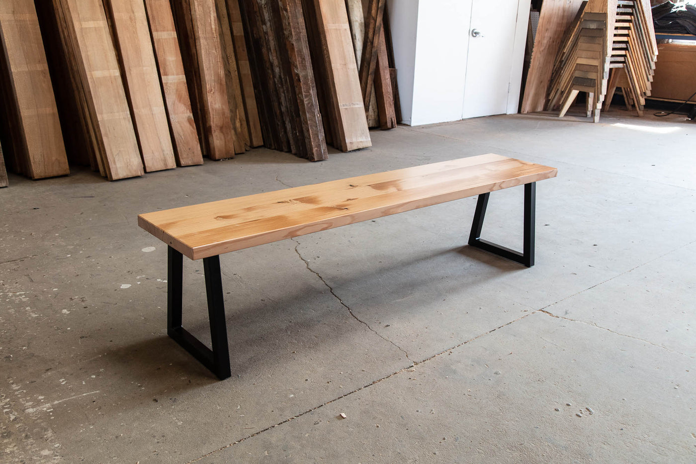 Natural wood bench with black metal base