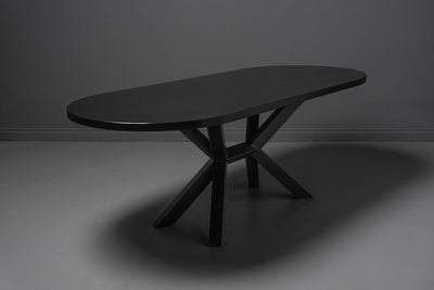 Modern black wooden table with clean lines placed against a neutral grey wall
